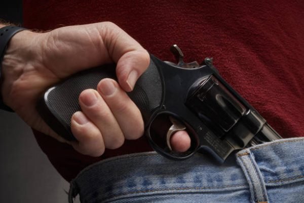 Man pulling a concealed .41 Magnum pistol from his waistband in Golden, Colorado, United States